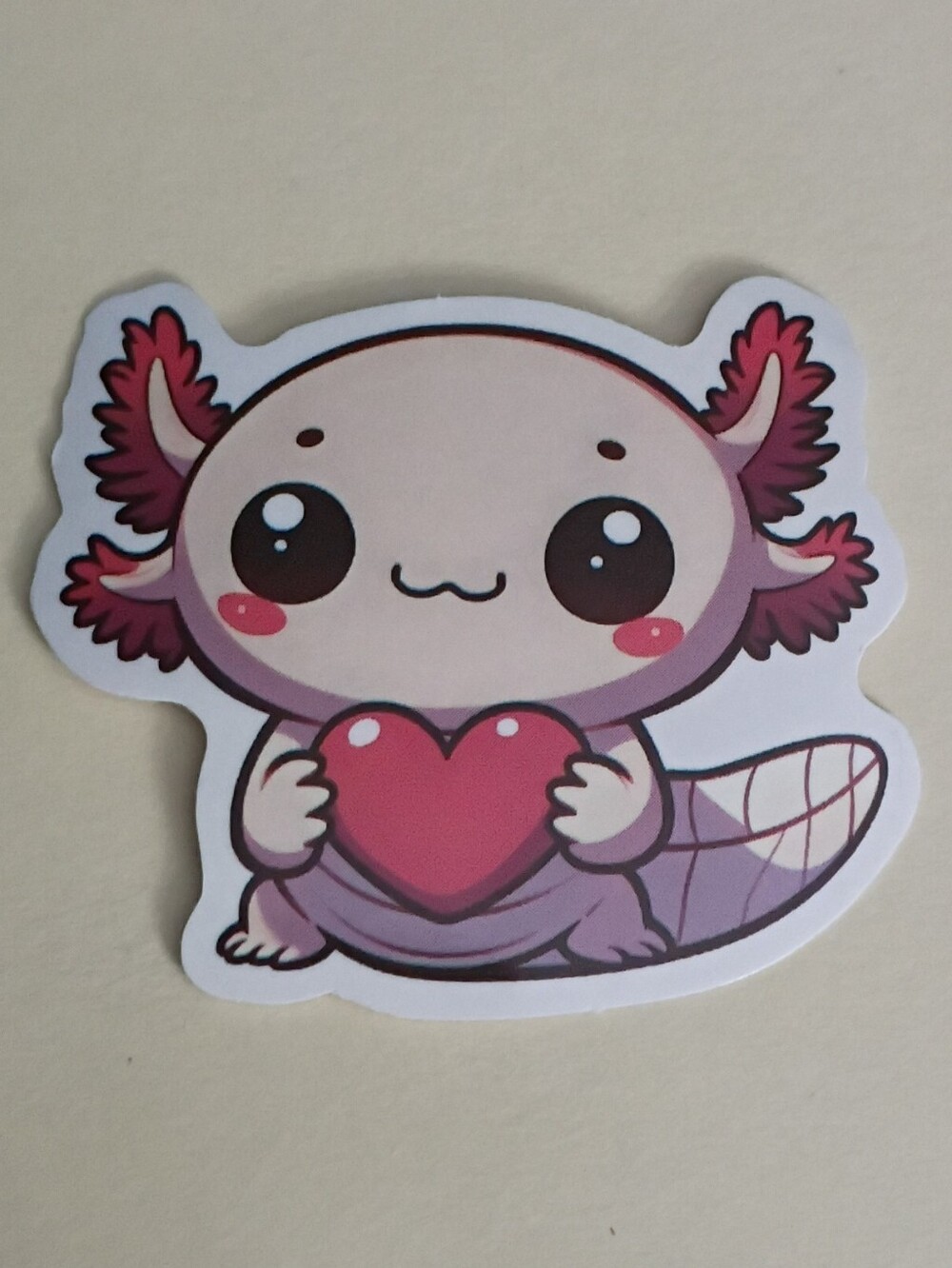 10/$10 Sticker - Pink Axolotl Pale Pink To Red Holding Red Heart